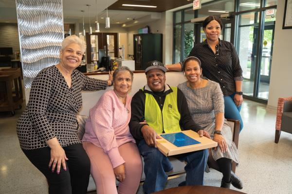 CHA Staff members pose with senior resident Ollie Chambers