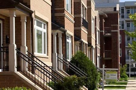 Walk-up apartments with a for rent sign in front